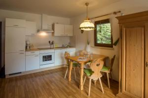 a kitchen with a table and chairs and a dining room at Zugspitz Traumapartment in Farchant