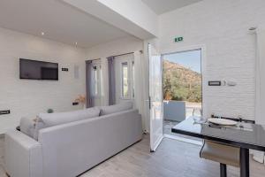 a living room with a white couch and a table at Seaside Suite in Galissas