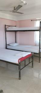 two bunk beds in a room with a ceiling at Backpackers' Haven in Guwahati