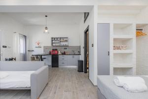 a living room with two beds and a kitchen at Seaside Suite in Galissas