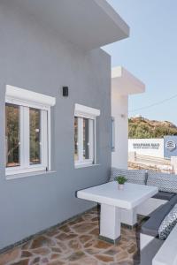 a white room with a white table and windows at Seaside Suite in Galissas