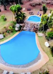 an aerial view of two swimming pools at a resort at Recanto Ganesha Pousada in Serra do Cipo