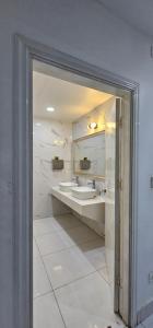 une salle de bain avec deux lavabos et un miroir dans l'établissement Indian Valley Guest House, à Sihanoukville 13 autres photos