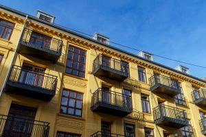 a yellow building with balconies on the side of it at MAYA Apartments - Frogner in Oslo