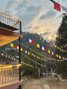 a string of colorful flags hanging from a building at the pahadi ghar in Gushaini +14 photos