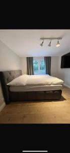 a large bed in a room with a window at Home in Grengiols