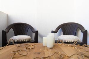 una mesa de madera con 2 sillas y una mesa con velas en Amaria Sunrise, en Popeşti-Leordeni