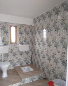 a bathroom with a sink and a toilet at Backpackers' Haven in Guwahati