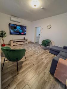 a living room with a couch and a tv at Casa Passa Tempo in Aldeia do Mato