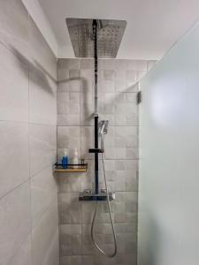 a shower with a shower head in a bathroom at Casa Passa Tempo in Aldeia do Mato