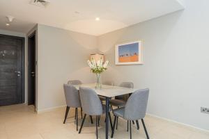 a dining room with a table and chairs at Urban Chic - Mangrove Place in Abu Dhabi
