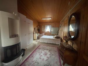 a bedroom with a bed and a fireplace in a room at Villa Sillankorva in Viitasaari