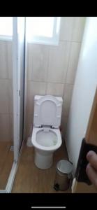 a bathroom with a toilet in a small room at Vista Clara in Ponta do Sol +6 photos