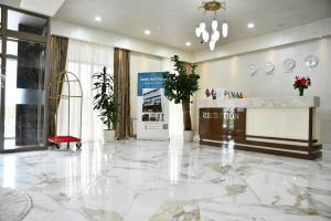 a lobby with a marble floor and a reception desk at Park Naftalan Sanatoriya Kompleksi in Naftalan