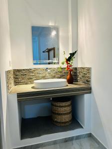 a bathroom counter with a sink and a mirror at The Opulent Retreat in Ahangama