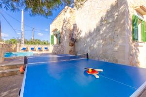 a ping pong table with two ping pong balls on it at Villa Sa Llimonera by Slow Villas in Cala Llombards