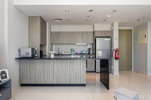 a kitchen with a counter and a refrigerator at Urban Chic - Shams Meera in Abu Dhabi