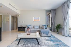 a living room with a couch and a table at Urban Chic - Shams Meera in Abu Dhabi