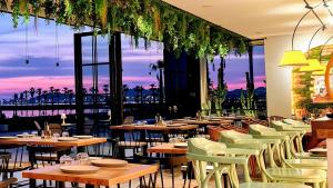 a restaurant with tables and chairs with a view at Beachfront Boutique Apartments in Durrës