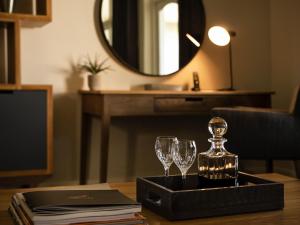 a tray with wine glasses and a mirror on a table at Founders Lodge by Mantis in Paterson +138 photos