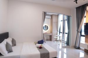 a bedroom with a large bed and a large window at The Shore LW Premium Suites KK Downtown in Kota Kinabalu