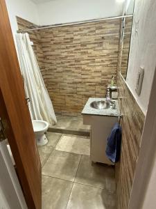 a small bathroom with a sink and a toilet at La posada de Majo 1 in Pergamino