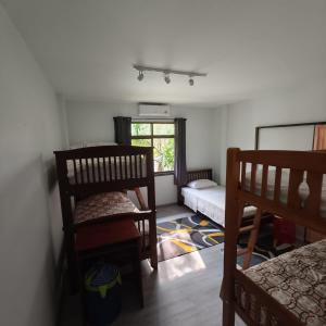 a room with two bunk beds and a window at New! MATA Garden resort Ao Nang in Ao Nang Beach