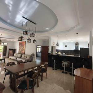 a living room with a table and a piano at New! MATA Garden resort Ao Nang in Ao Nang Beach