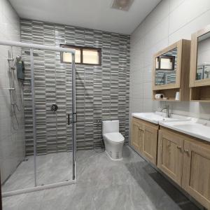 a bathroom with a shower and a toilet and a sink at New! MATA Garden resort Ao Nang in Ao Nang Beach