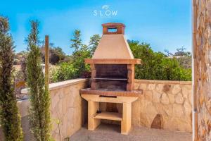 a outdoor oven sitting on top of a stone wall at Villa Sa Llimonera by Slow Villas in Cala Llombards