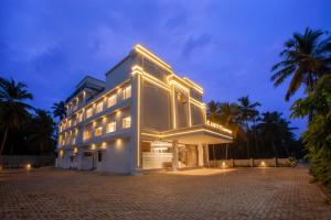 a large white building with lights on it at night at Amity's Courtyard in Jāmb