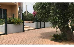 a gate to a house with a brick walkway at Villa Costa del Sole - Capitolo in Monopoli +6 photos