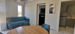 a living room with a table and a blue couch at Residence Niko in Pratica di Mare