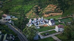 un groupe de maisons sur une colline à côté d'une route dans l'établissement Montagna Luxury Hotel, à Nuwara Eliya