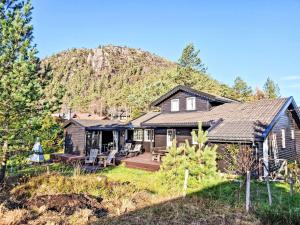 a house with a mountain in the background at Holiday Home Lettibu by Interhome in Madland