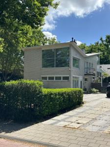a large house with a lot of windows at Villa Vista in Wassenaar