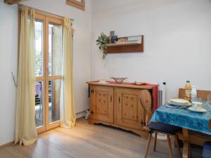 a dining room with a table and a wooden cabinet at Apartment Breithorn Residence Apt-09 by Interhome in Wengen +22 photos