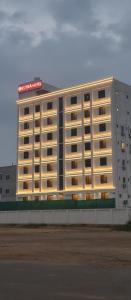 a hotel building with a sign on top of it at Klyra Hotel in Hyderabad