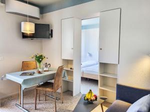 a small room with a table and a bed at Apartment Residenza Corallo Apt-201 B by Interhome in Ascona