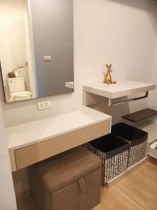 a bathroom with a mirror and a white counter at Z cape 1 one one in Laguna Phuket