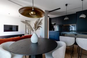 a kitchen and dining room with a table and chairs at Suite Plaza Nueva in Seville
