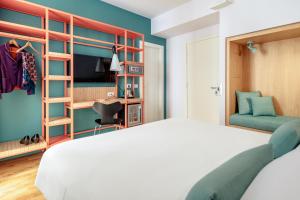 a bedroom with a white bed and a green wall at Hotel Piazza Bellini & Apartments in Naples