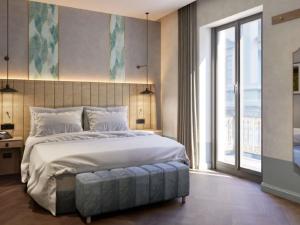 アルバにあるHotel Giacomo Morra Alba - Handwritten Collectionの大きなベッドと大きな窓のある寝室