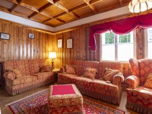 a living room with two couches and a table at Chalet Chalet Franca by Interhome in Madesimo
