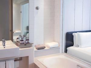 a bathroom with a sink and a mirror at Grand Mercure Shanghai Century Park- Free Shuttle Bus to SNIEC in Shanghai