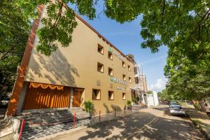 a building on the side of a street at Hotel Mint in Thane