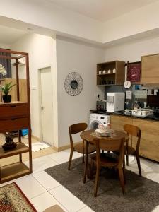 a kitchen and dining room with a table and chairs at Timurbay Residence Resort Style in Kuantan +5 photos