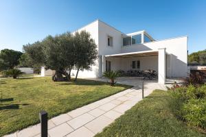 莫诺波利HelloAPULIA Villa Annita - Enchanting Sea-View Villa - superb location 2 minutes from beach and restaurants的白色的房子,设有庭院和庭院