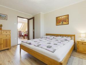 a bedroom with a bed and a dresser and a table at Apartment Pajtas 1 by Interhome in Balatonfenyves +24 photos