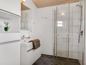 a bathroom with a sink and a shower at Holiday Home Skarthi - 200m from the sea by Interhome in Sæby +15 photos